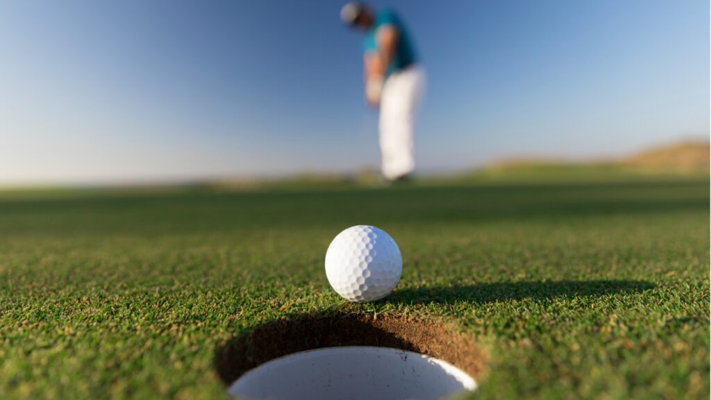 golf ball entering the hole after successful stroke close up links picture id1148643923