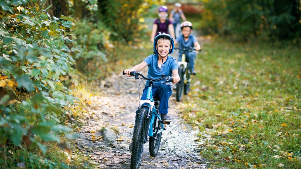 little boy and his family riding bicycles in nature picture id1046422550